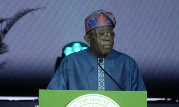 President Bola Tinubu speaking at a podium